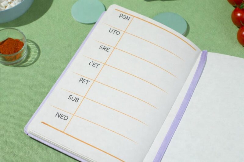 Weekly meal planning notebook on a kitchen table